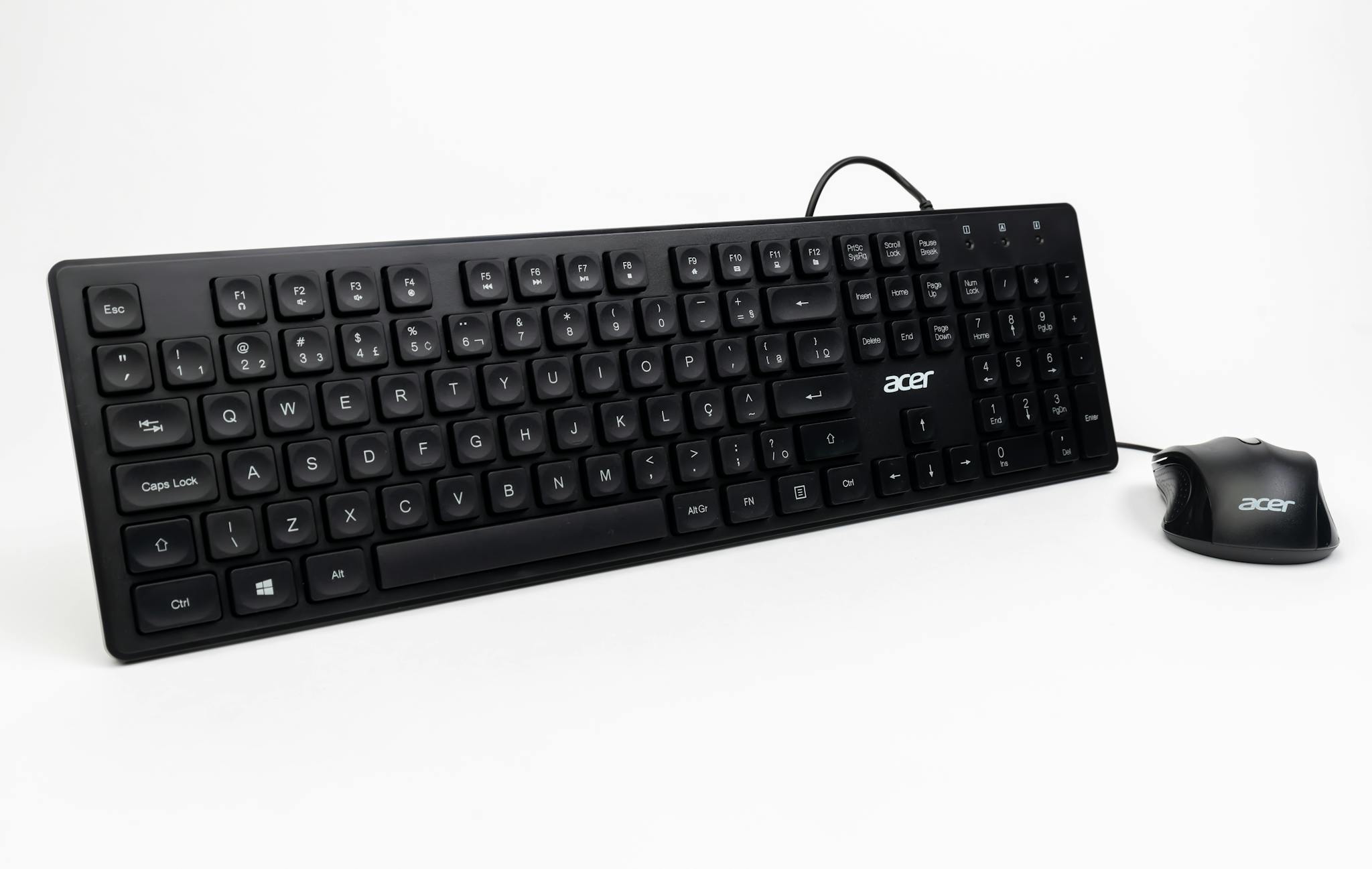 Black keyboard and mouse set placed on a white background, perfect for office and tech-related uses.